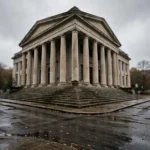 Exterior of a courthouse building with tall columns and steps under an overcast sky.