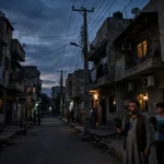 Karachi residential street at night during K-Electric power outage amid RLNG shortage October 2026