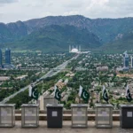 Empty ballot boxes with Pakistani flags overlooking the Islamabad skyline with the Faisal Mosque and Margalla Hills, as the ECP moves to schedule the capital's long-delayed local government elections