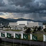 Pakistan's Parliament House in Islamabad with national flags under stormy skies as federal cabinet weighs emergency and governor's rule in KP October 2026