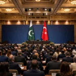 Delegates seated in a grand conference hall in Istanbul with the flags of Pakistan and Turkiye displayed on stage during the International Justice Summit 2026