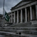 Pakistani flag at half-mast in front of a government building as Pakistan mourns ECP Director General Shamshad Akhtar after Tank attack October 2026
