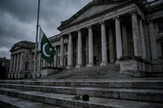 Pakistani flag at half-mast in front of a government building as Pakistan mourns ECP Director General Shamshad Akhtar after Tank attack October 2026