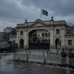 Security personnel near barbed-wire barricades outside a Khyber Pakhtunkhwa government building in Peshawar after CM Sohail Afridi was taken into preventive custody in October 2026