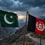 Flags of Pakistan and Afghanistan at a fenced mountain border crossing at dusk as Deputy PM Ishaq Dar warns the Afghan Taliban regime of consequences over terrorism inaction, October 2026