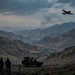 A trainer aircraft flying over mountains near Quetta with a distant column of smoke as two Pakistan Army pilots were martyred in a Mushshak crash in October 2026
