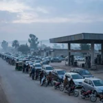 Cars and motorbikes queuing at a petrol station in Pakistan at dawn